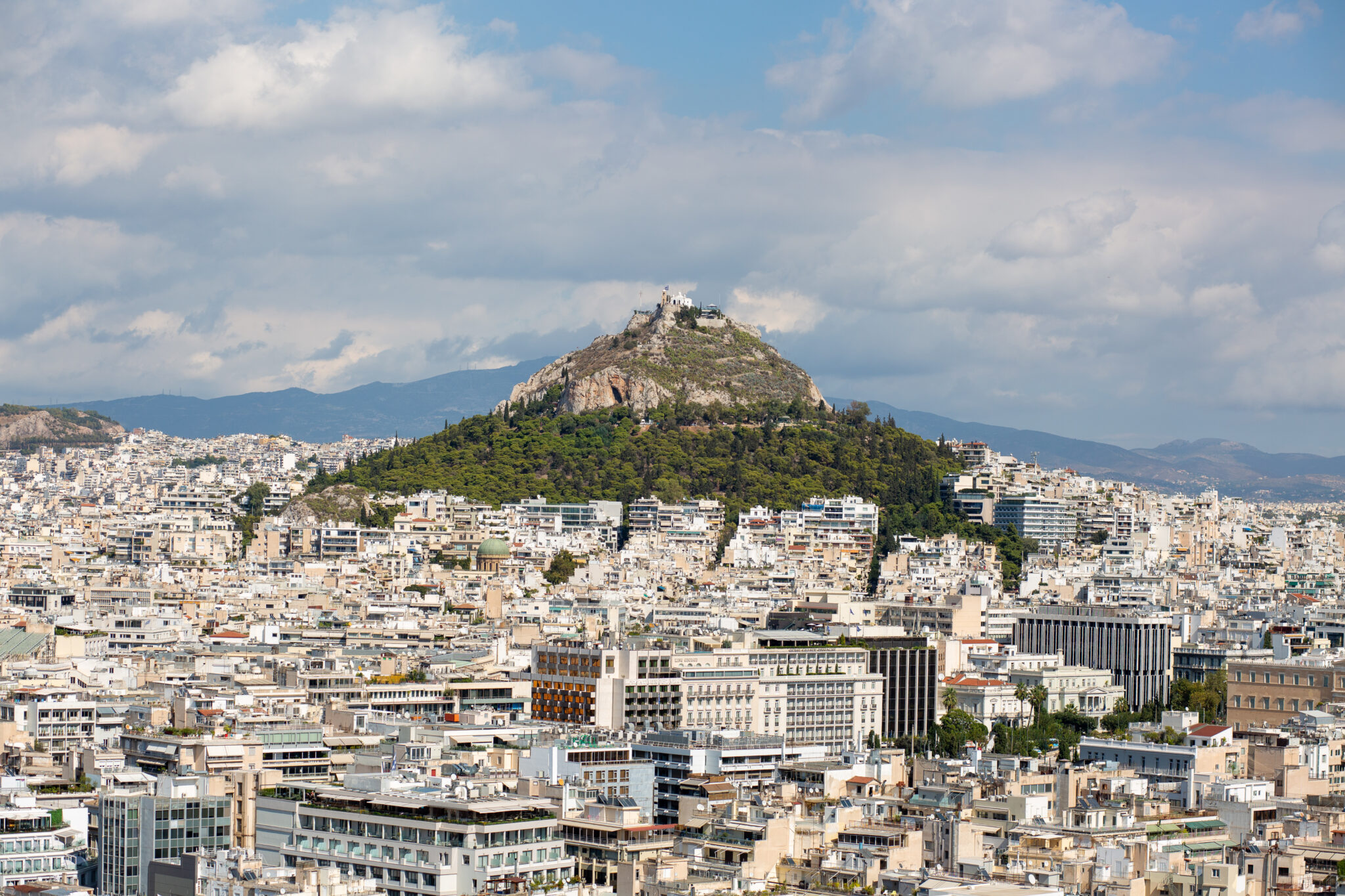 An aerial view of buildings and hills in Athens, Greece