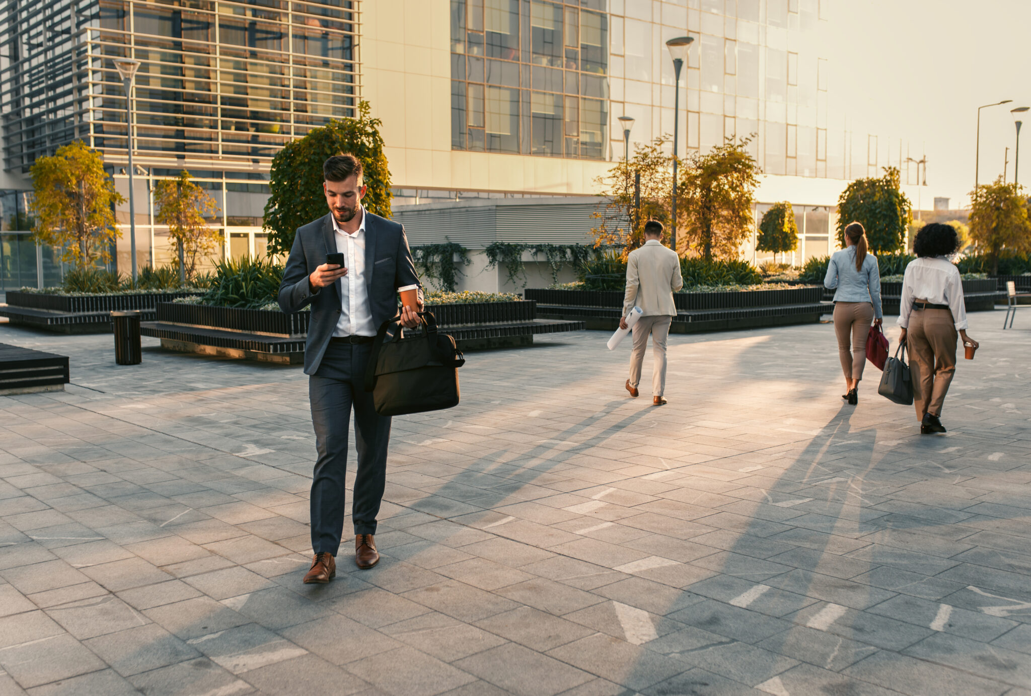 Group,Of,Business,People,Walking,Outside,In,Front,Of,Office